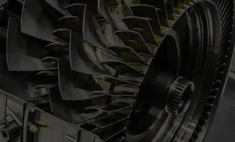 Close-up of jet engine turbine blades showing intricate metal details.