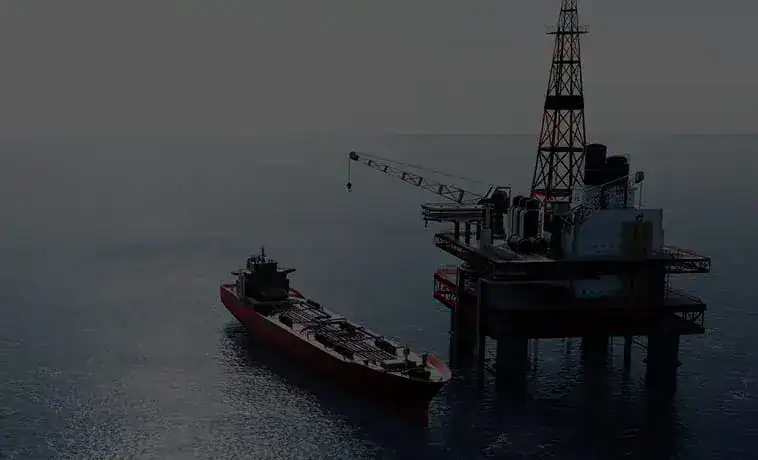 Offshore oil platform with supply vessel in calm sea at dusk.