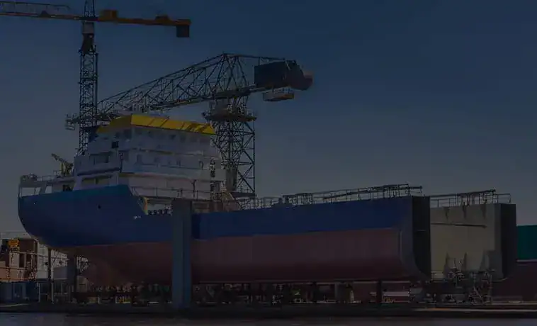 A large ship under construction with crane at Asonext shipyard.