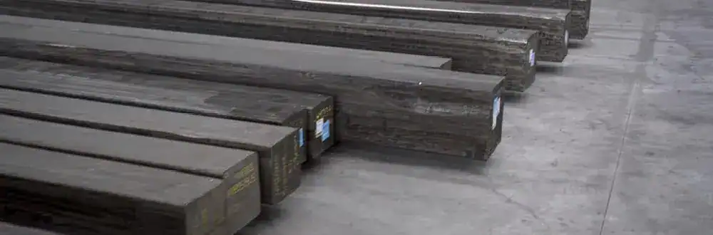 Steel beams stacked in a warehouse for construction projects.